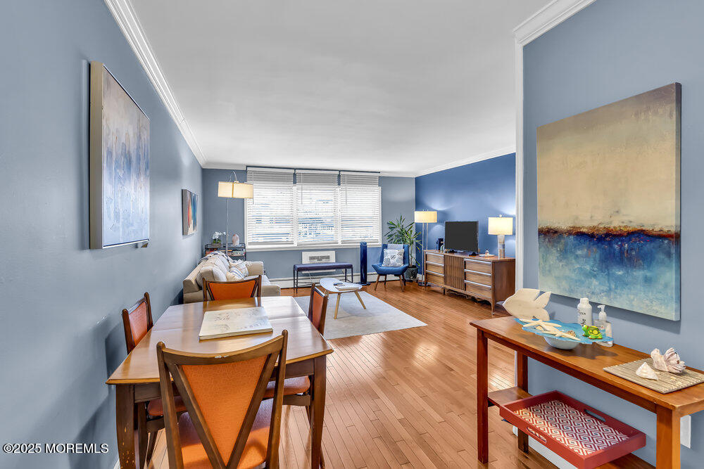 317 8th Avenue, Unit 303 Asbury Park, NJ 07712 - Photo 3 of 15 a dining room with furniture and wooden floor