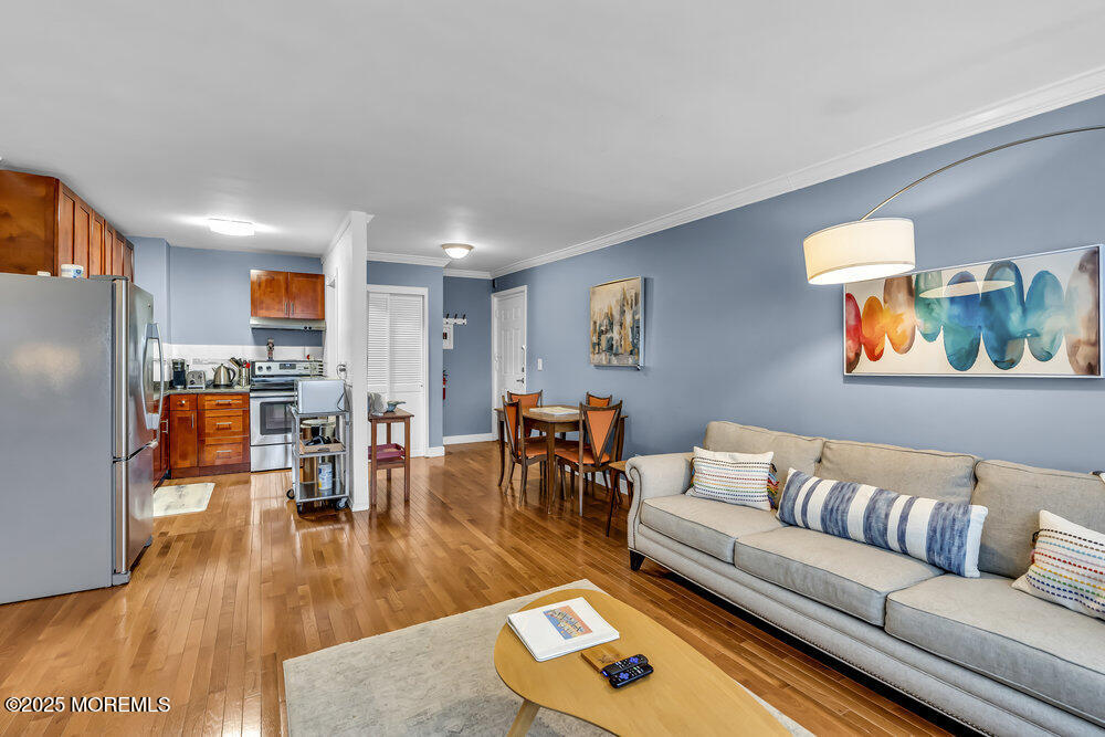 317 8th Avenue, Unit 303 Asbury Park, NJ 07712 - Photo 6 of 15 a living room with furniture and a wooden floor