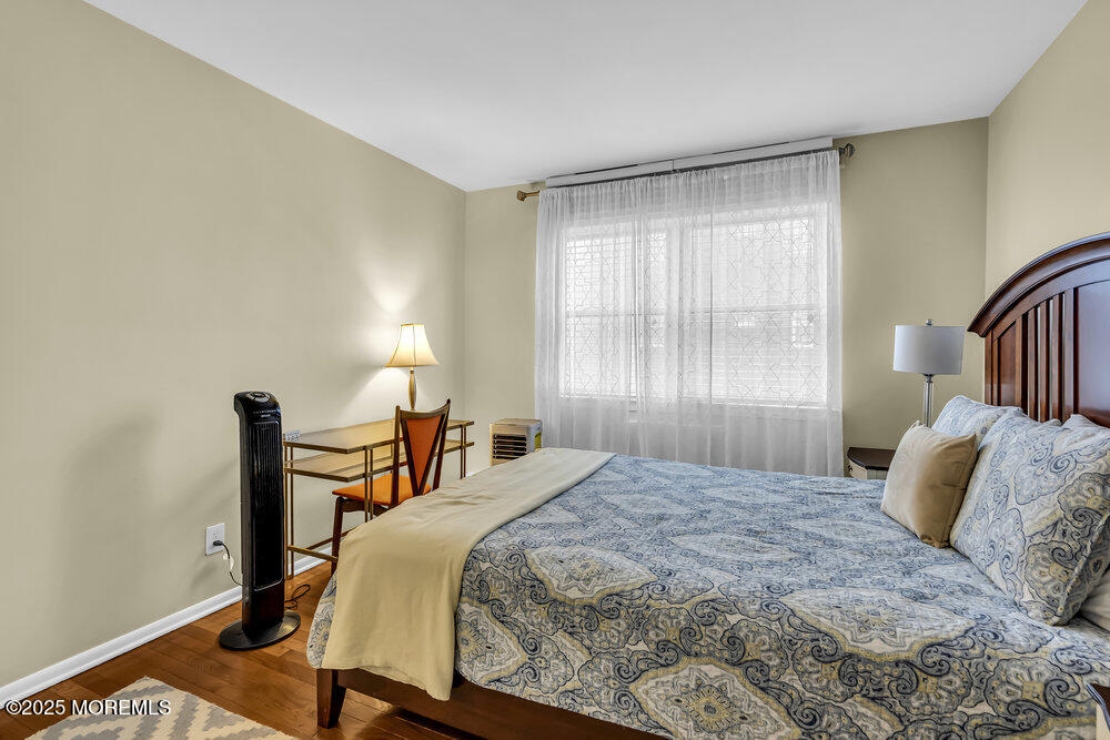 317 8th Avenue, Unit 303 Asbury Park, NJ 07712 - Photo 10 of 15 a bedroom with a bed and a window
