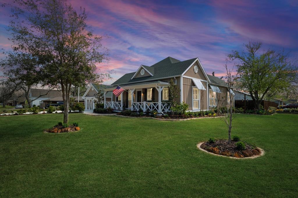 301 East Division Street Pilot Point, TX 76258 - Photo 1 of 1 a front view of a house with a yard fire pit and outdoor seating