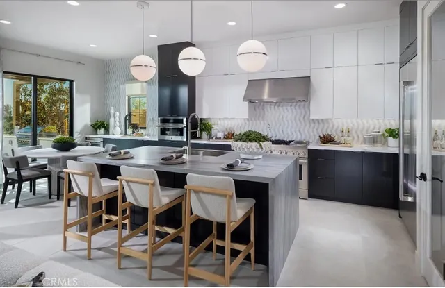 a kitchen with a dining table cabinets and sink
