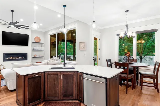 a kitchen with a sink a counter top space and stainless steel appliances