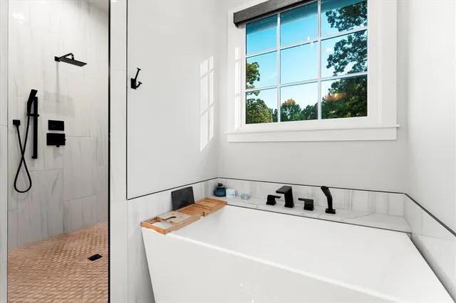 a utility room with shower and window