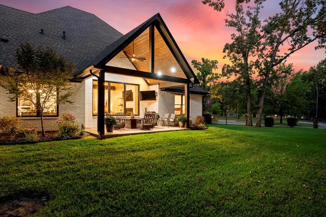 a view of a house with backyard and sitting area