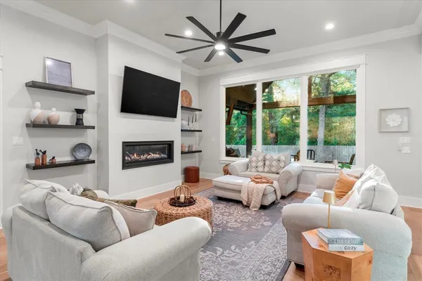 a living room with furniture and large windows