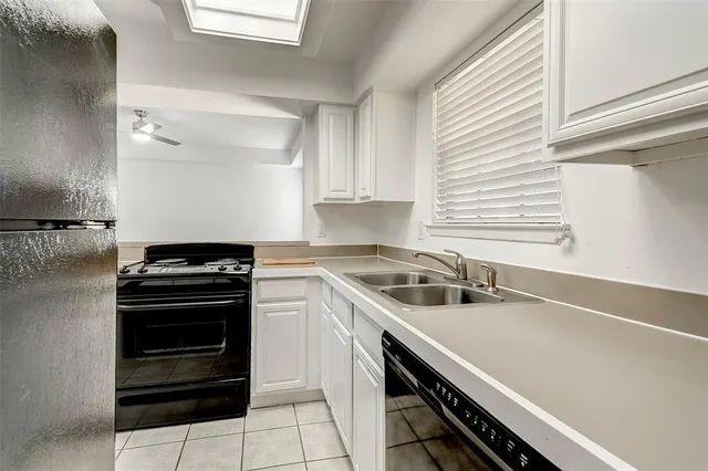 a kitchen that has a sink and a stove