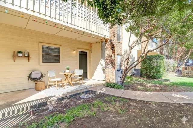 a backyard of a house with table and chairs