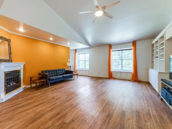 a view of empty room with a kitchen and fireplace