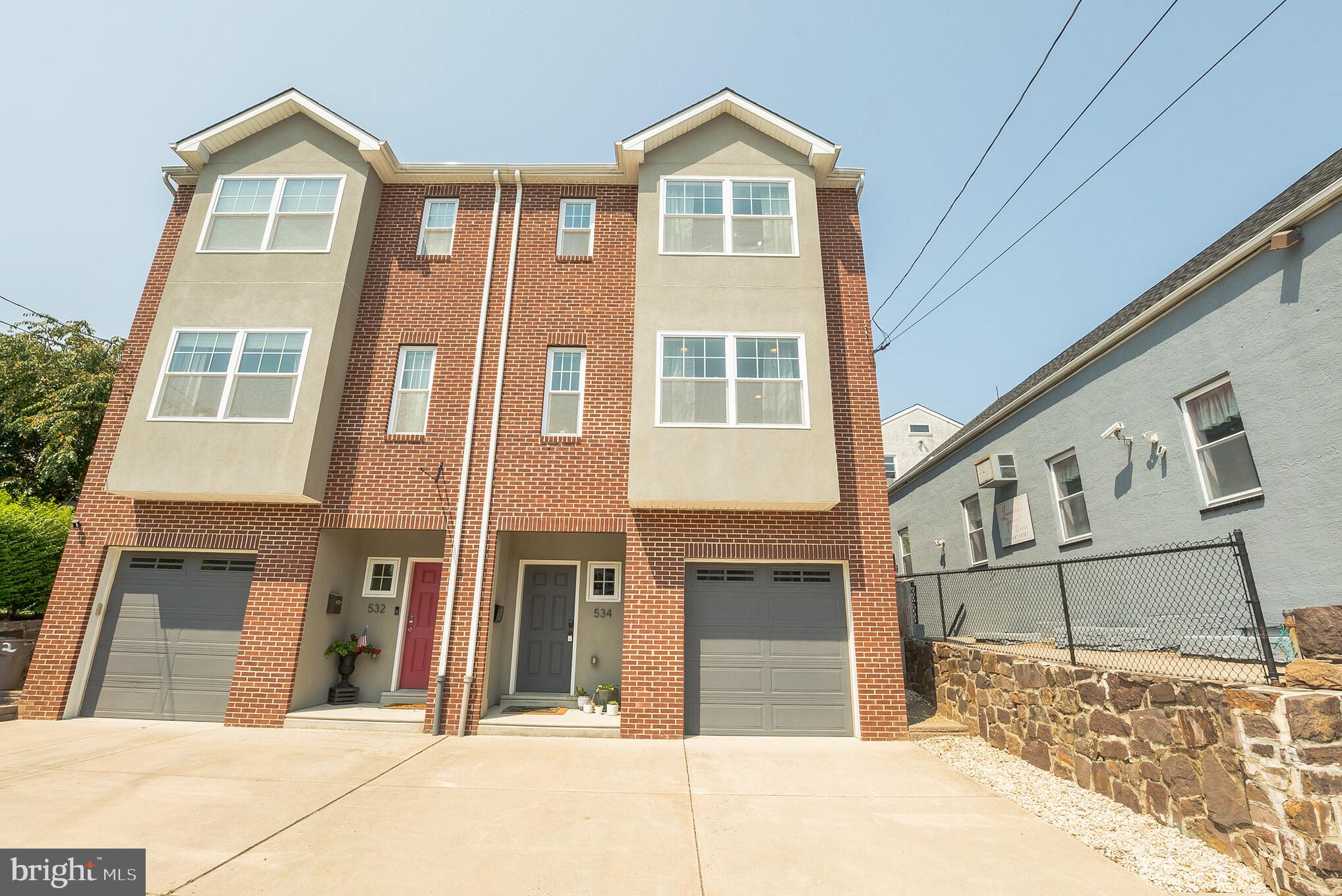 a view of a brick house with large windows