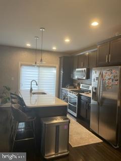 534 Green Lane Philadelphia, PA 19128 - Photo 11 of 43 a kitchen with stainless steel appliances granite countertop a sink a stove and a refrigerator