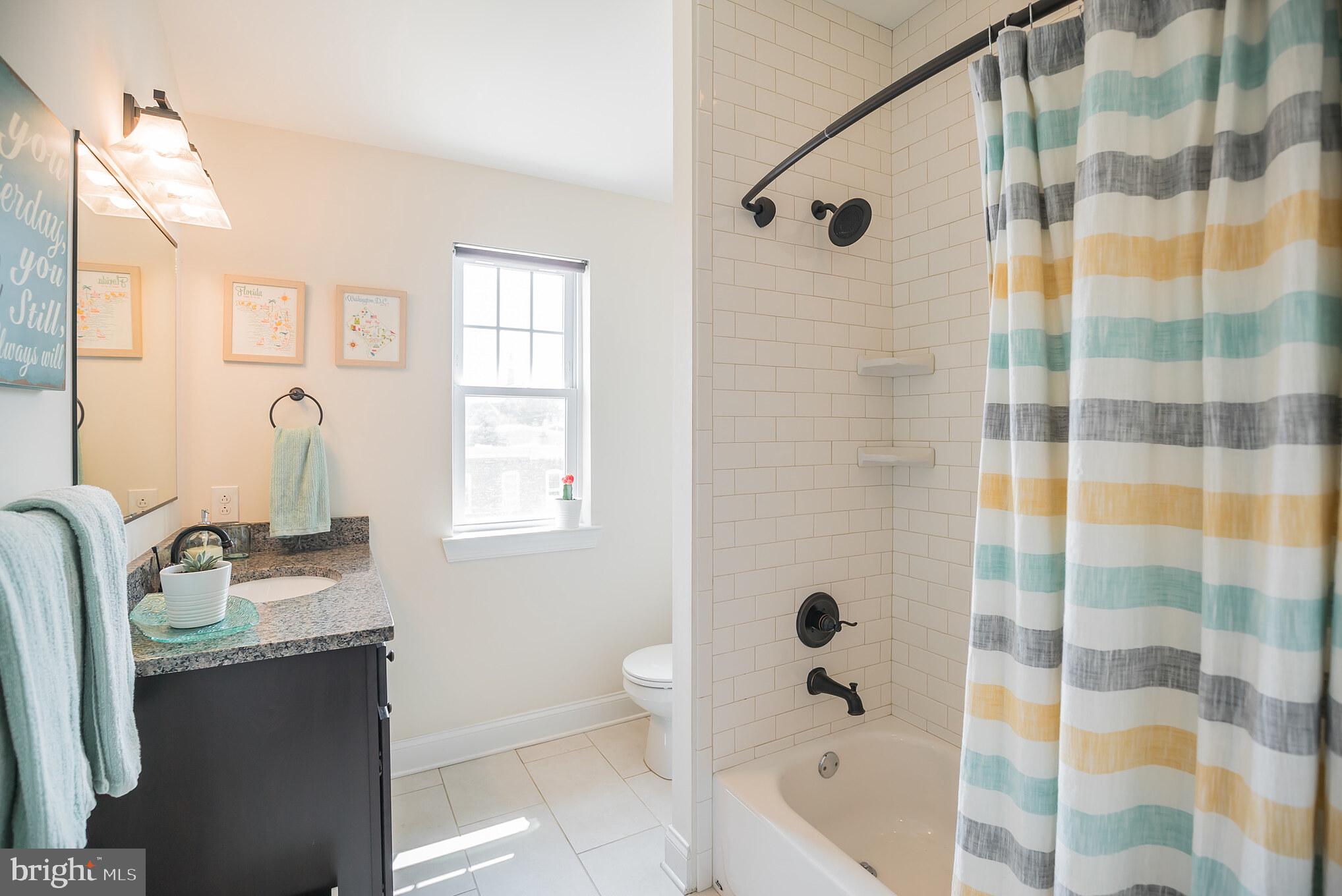 534 Green Lane Philadelphia, PA 19128 - Photo 28 of 43 a bathroom with a granite countertop sink a mirror a bathtub and shower