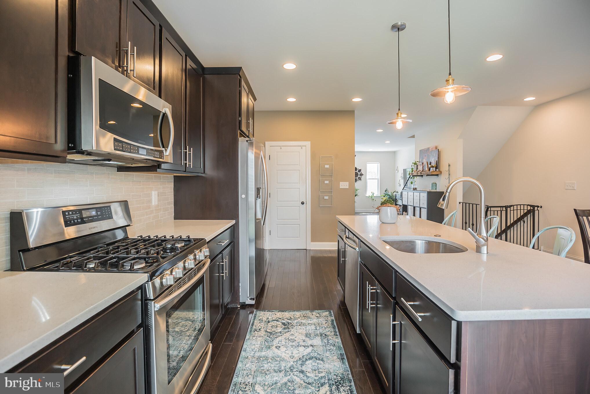 534 Green Lane Philadelphia, PA 19128 - Photo 3 of 43 a kitchen with stainless steel appliances granite countertop a sink a stove and a refrigerator