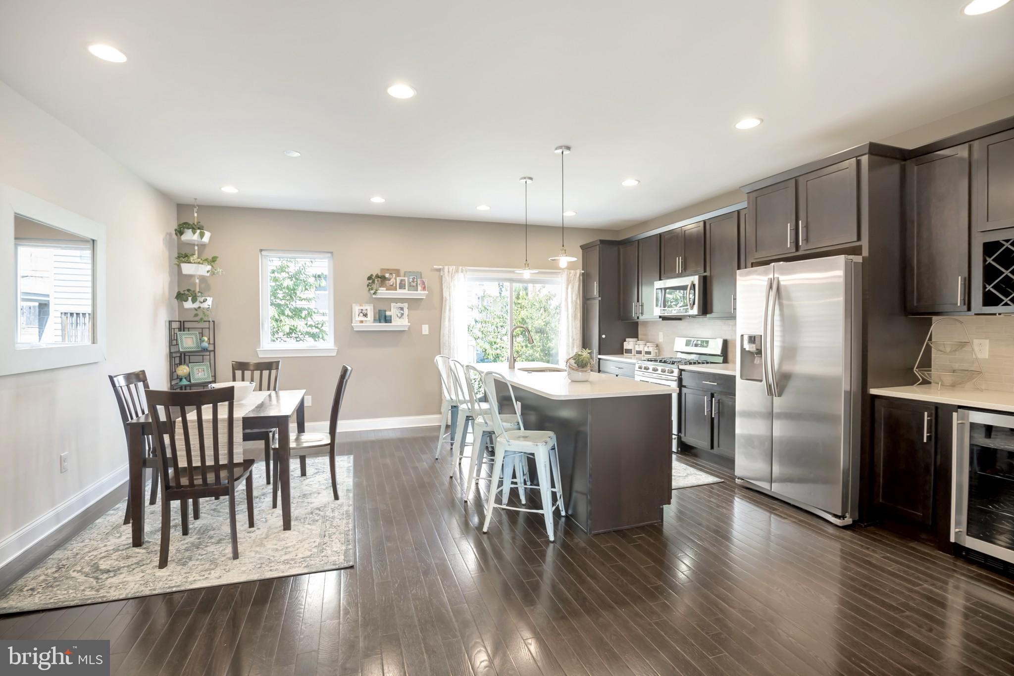 534 Green Lane Philadelphia, PA 19128 - Photo 4 of 43 a kitchen with a dining table chairs refrigerator and cabinets