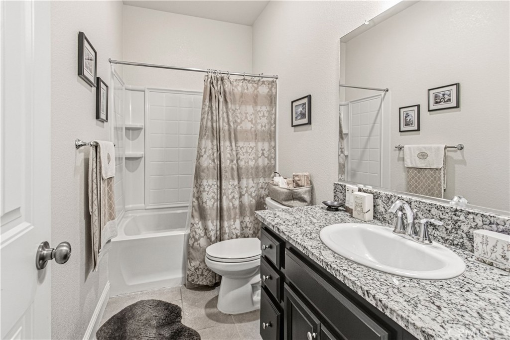 3716 Magellan Drive Merced, CA 95340 - Photo 15 of 27 a bathroom with a granite countertop sink toilet and shower