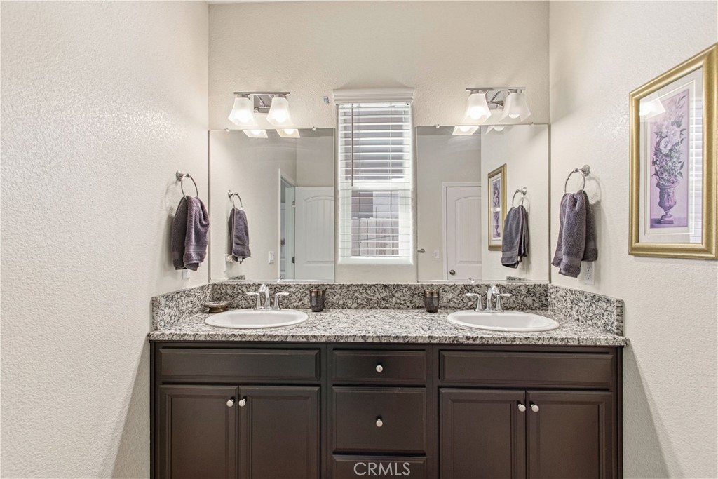 3716 Magellan Drive Merced, CA 95340 - Photo 19 of 27 a bathroom with double vanity sinks and a mirror