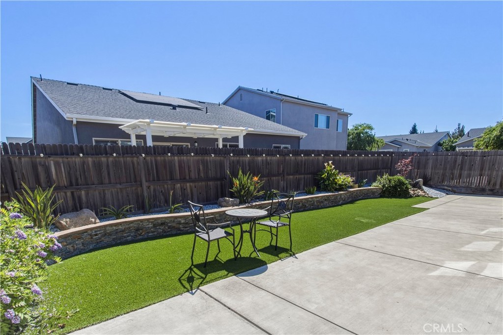 3716 Magellan Drive Merced, CA 95340 - Photo 22 of 27 a view of a chair and table in backyard