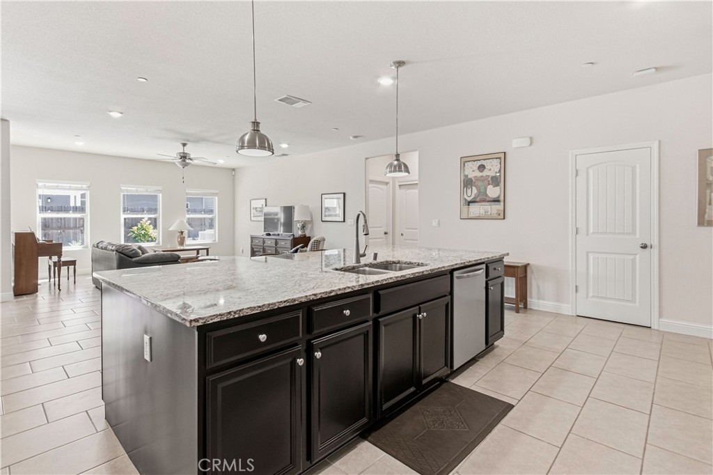 3716 Magellan Drive Merced, CA 95340 - Photo 4 of 27 a kitchen with stainless steel appliances granite countertop a sink a counter space and wooden floor
