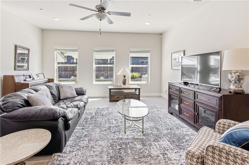 3716 Magellan Drive Merced, CA 95340 - Photo 8 of 27 a living room with furniture and a flat screen tv