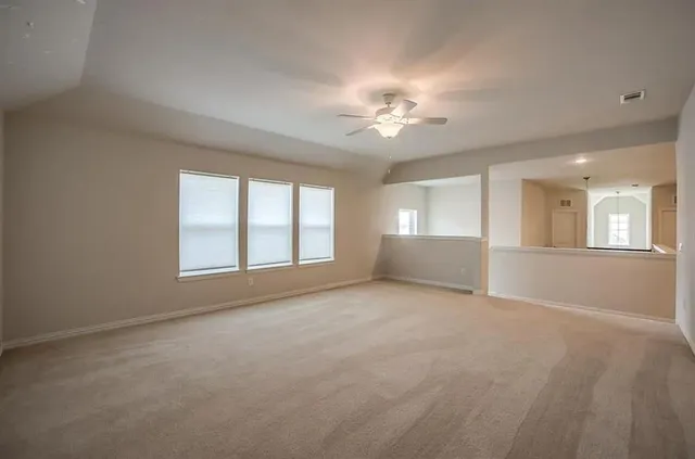 a view of empty room with a fireplace