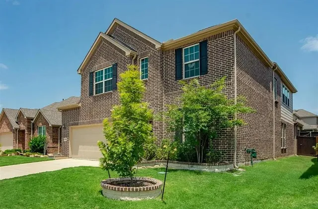 a front view of house with a garden