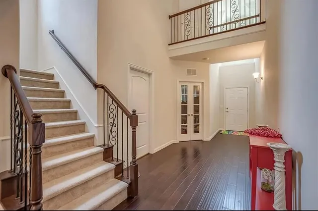 a view of a hallway with wooden floor and entryway