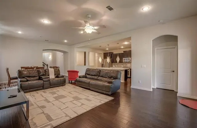 a living room with furniture and wooden floor