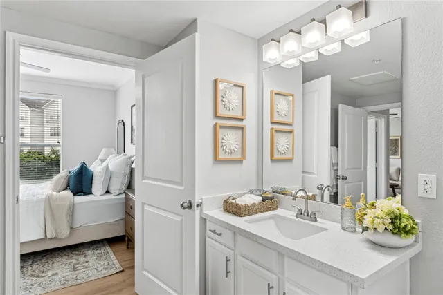 a bathroom with a tub sink and mirror