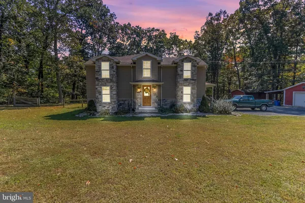 a front view of house with outdoor space and garden