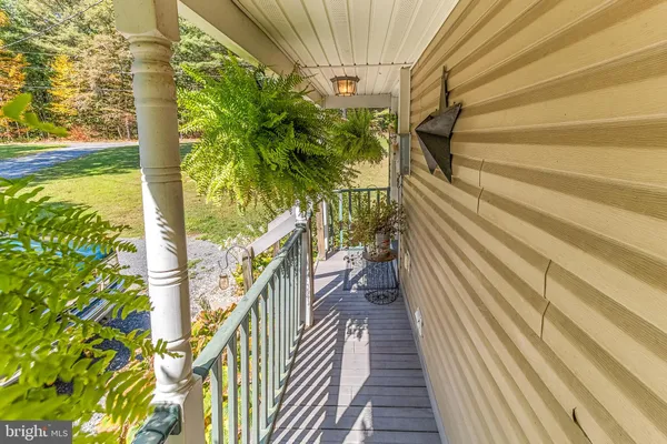 a aerial view of a house with a yard and lake view