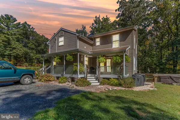 a view of a house with patio and a yard