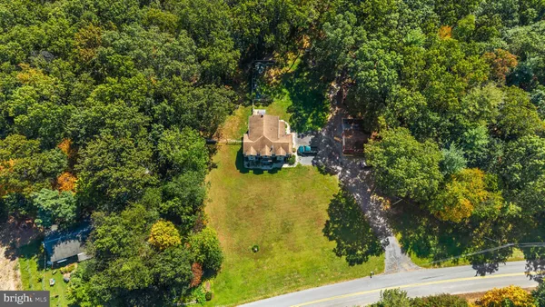 a patio with table and chairs and potted plants