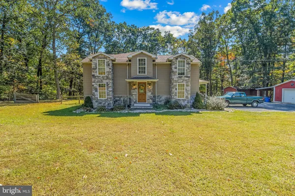 a bathroom with a sink and mirror with toilet