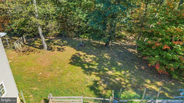 a view of a room with a wooden floor and a window