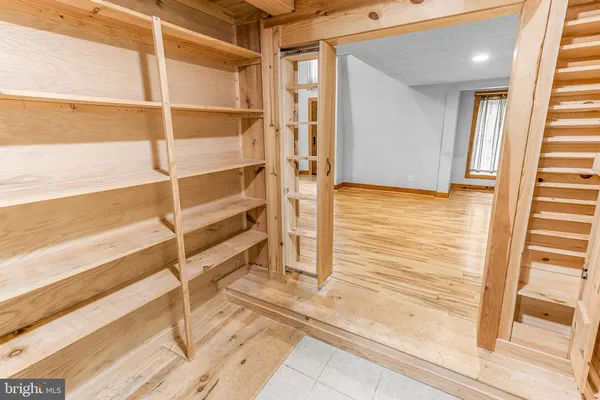 a view of an entryway with wooden floor and a livingroom