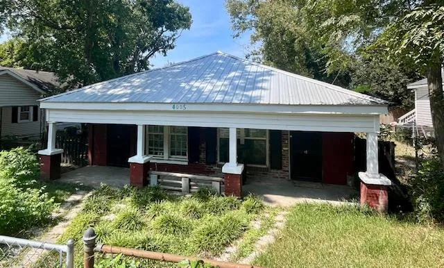a view of a house with sitting area and garden