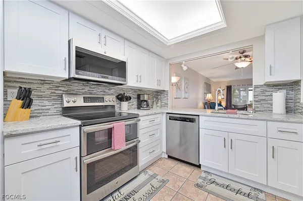 a kitchen with stainless steel appliances granite countertop a sink and a stove