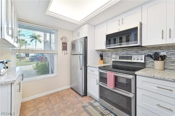 a kitchen with stainless steel appliances granite countertop a refrigerator and a stove
