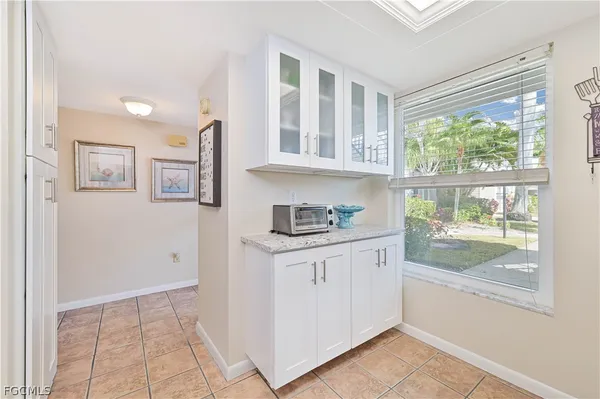 a kitchen with granite countertop a stove a sink and a refrigerator