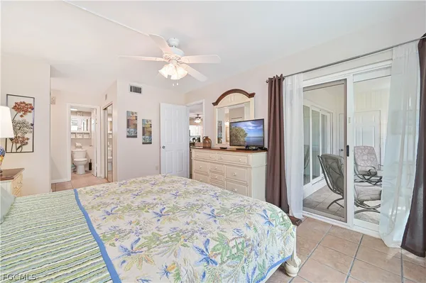a bedroom with a large bed and a view of living room