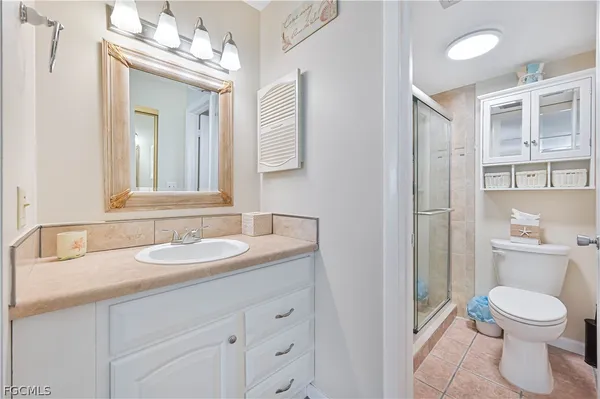 a bathroom with a toilet a sink and a mirror