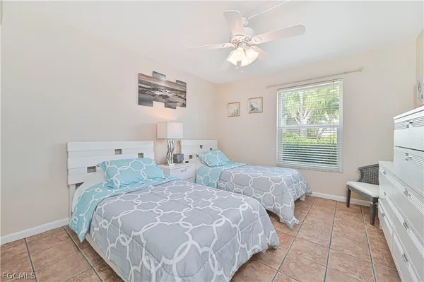 a bedroom with two beds and a large mirror