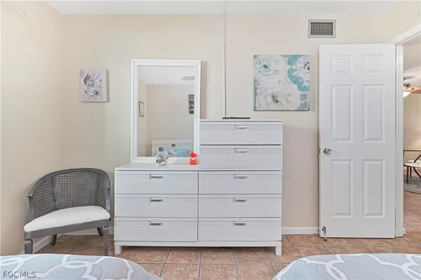 a bedroom with a bed and cabinet
