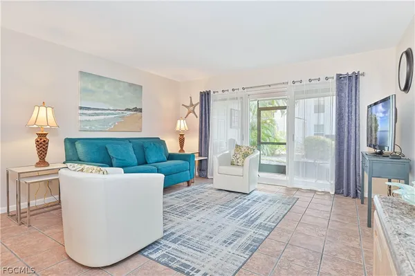 a living room with furniture and a large window