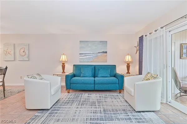 a living room with furniture and a rug