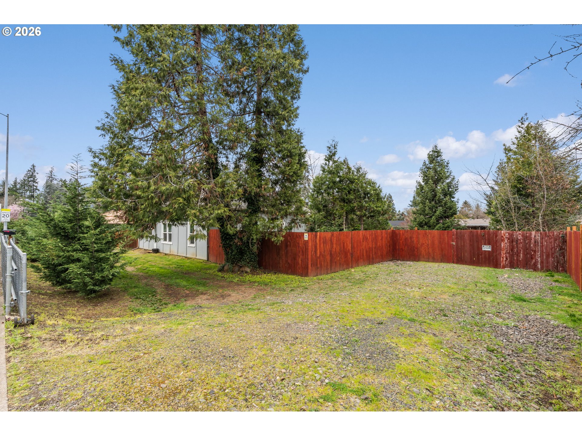 3315 West 18th Avenue Eugene, OR 97402 - Photo 20 of 26 a view of a yard with an tree and wooden fence