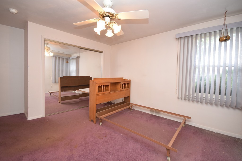 167 Woodcrest Road Springfield, MA 01129 - Photo 14 of 22 an empty room with windows and ceiling fan