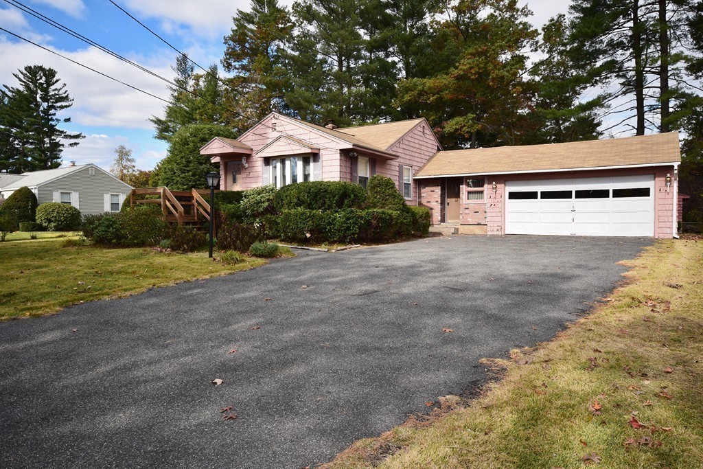 167 Woodcrest Road Springfield, MA 01129 - Photo 17 of 22 a front view of a house with a yard and garage