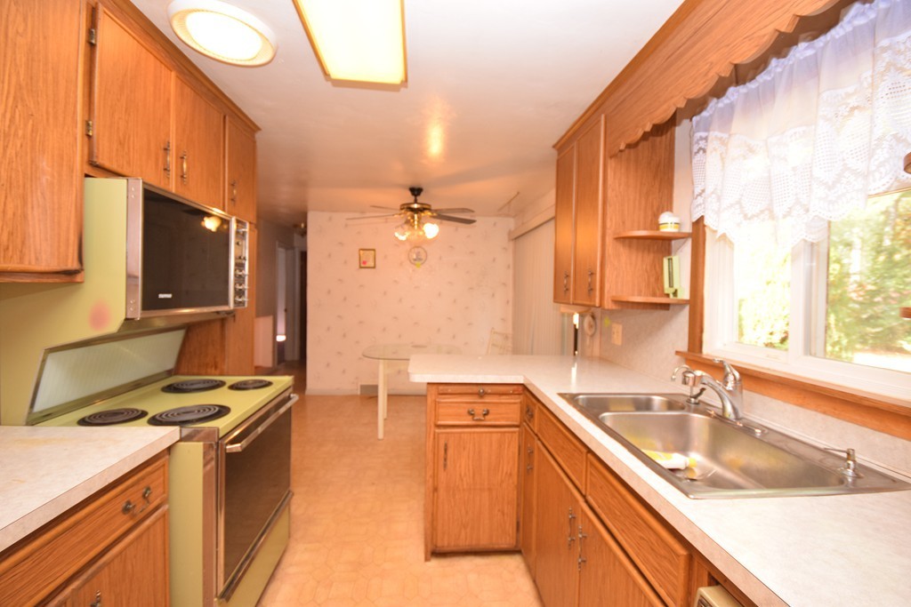 167 Woodcrest Road Springfield, MA 01129 - Photo 3 of 22 a kitchen with a sink stove top oven and cabinets