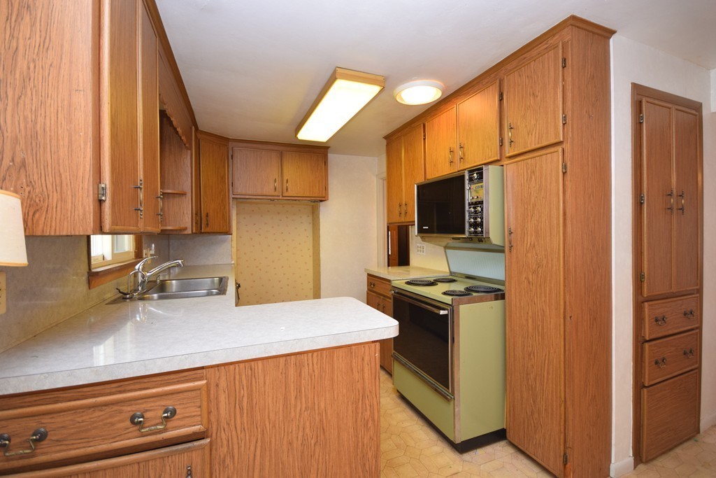 167 Woodcrest Road Springfield, MA 01129 - Photo 10 of 22 a kitchen with stainless steel appliances a stove microwave and refrigerator