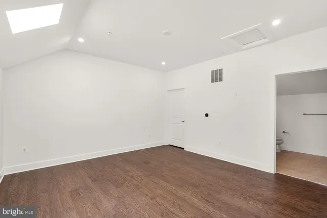 a bathroom with a granite countertop sink a toilet and a mirror